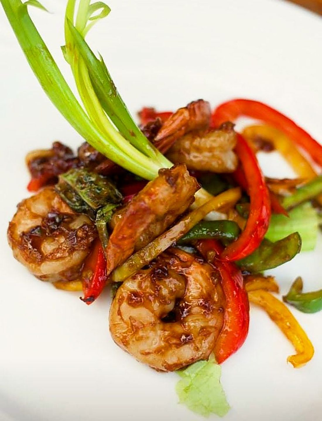Prawns tossed with peppers and spring onion