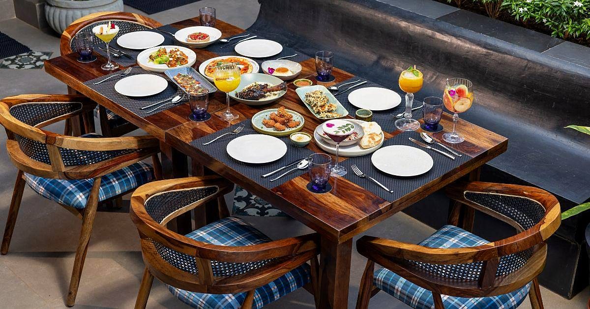 A table set with plates from the kitchen and fresh fruit drinks